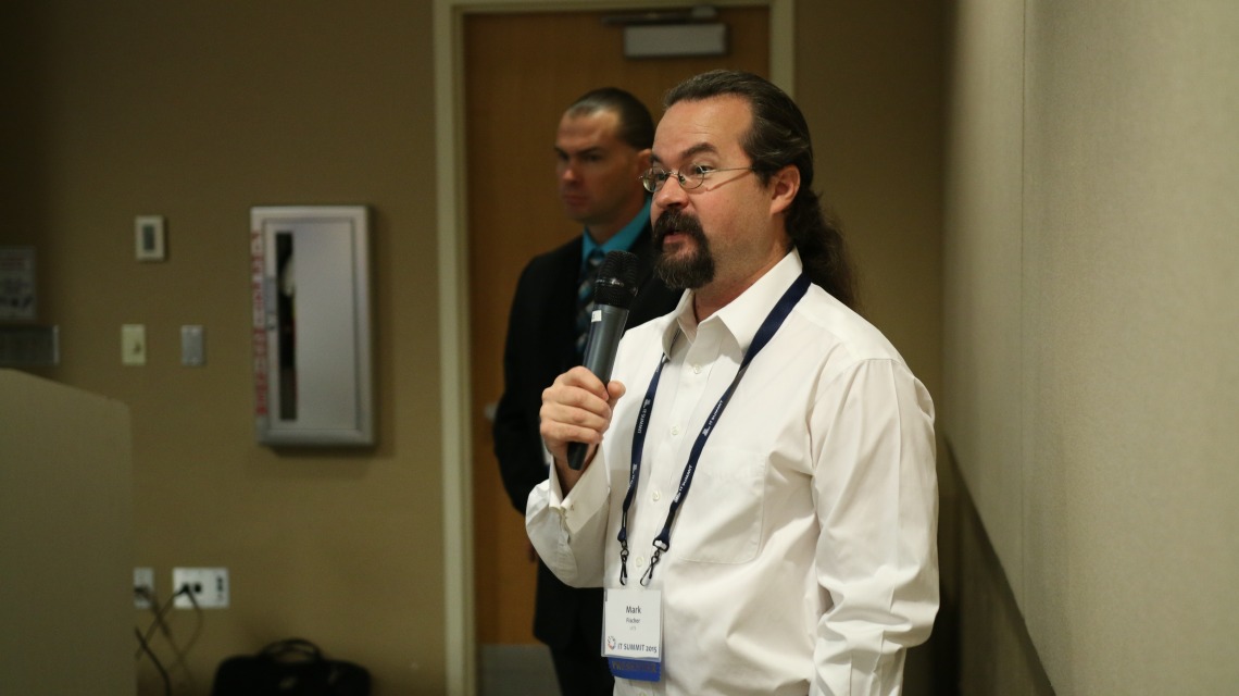 A person speaking at the IT Summit
